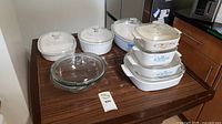 Overview of all ceramic and glass cookware items showing variety in sizes and shapes.