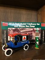 Box displaying the 1912 Ford Model T Delivery Car and Wayne Gas Pump Limited Edition coin bank set, branded Eden Haan.