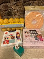 Lot components laid out including paper lanterns, Gelatos crayons, soap kit, and hole punch
