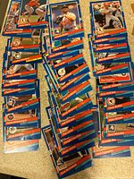 Photo showing multiple 1991 Donruss baseball cards arranged in rows, including players such as Jose Canseco, Randy Johnson, Mark McGwire, and others from various MLB teams.