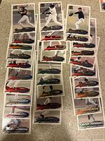 Photo showing 29 Pacific Paramount 1991 baseball cards laid out in rows on carpeted floor. Cards have player action and posed images with foil nameplate and team text.