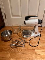 Overview image showing entire vintage mixer, three bowls placed aside, and metal mixer accessories including 2 pairs of beaters and 2 dough hooks.