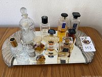 Perfume bottles arranged on Godinger vanity mirror, showing front row and back row bottles