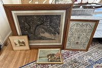 All four framed art pieces grouped on floor showing relative sizes and frames