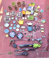 Full overview of gardening items, showing pots, gloves, potting soil bags, watering cans, hose connectors, nozzles, and power tools
