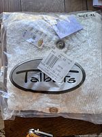White Talbots knit sweater with buttons sealed in plastic packaging, size XL, with tags visible.
