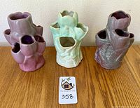 Front view of the three NILOAK mid-century flower vases showing aubergine and mint colors.