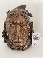 Front view of the cookie jar showing detailed American Indian face with feather headband and McCoy Cookies text at the base.