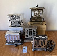 Photo of all five vintage toasters showing different brands and conditions with some lacking cords and one with notable rust.