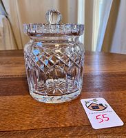 Full view of Waterford crystal lidded jar with lid in place on wooden surface with seller tag