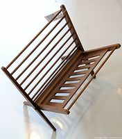 Front angled view showing slatted side panels and folding leg structure.