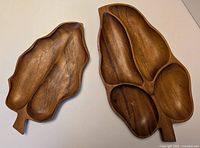 Top view of both Monkey Pod wood serving trays, showing natural wood grain and compartments in one tray