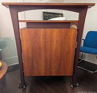 Front view of the solid wood reception bar, showing the rectangular top, raised ledge, and wood finish.