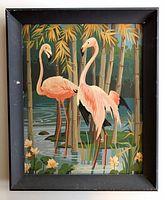 Full view of the vintage flamingo paint by number painting showing two pink flamingos standing in water with bamboo and flowers framed in black wood.