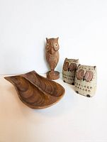 Front and angled view photo showing carved wooden owl figurine, wooden double dish tray, and two small ceramic owl figurines on a white surface.