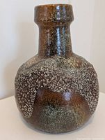 Front and side view of Dumler Breiden pottery vase showing rounded body with brown and grey textured glaze finish.