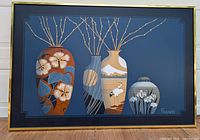 Front view of the large framed canvas print showing four decorated vases on a blue background, signed Franco