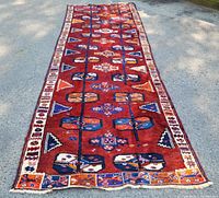 Full-length outdoor view of runner rug on pavement showcasing overall design