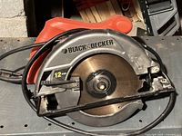 Side view of Black & Decker circular saw showing the blade guard, blade with 12 amp indicator, and power cord.