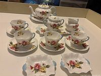 Overhead view of entire tea service showing all pieces arranged on table.