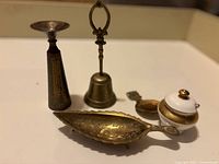 Top-down view showing the assorted vintage brass pieces arranged on a white surface.