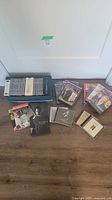 Collection of CDs and DVDs including boxed set, individual music CDs including Neil Diamond, and several DVDs like the Red Skelton Show.