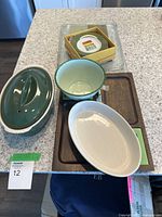 Overview of the kitchenware set arranged on wooden tray on kitchen counter.