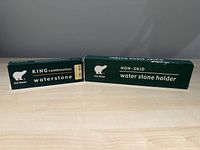 Box of Ice Bear KING combination waterstone with grit indicated (#1200 + #8000) and Ice Bear non-skid waterstone holder box on a wooden surface.