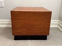 Front view of square end table showing wood grain and black base