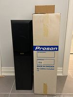 Single speaker unit next to original Proson packaging box