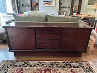 Front view of the rosewood veneer sideboard showing two cabinets and four central drawers.
