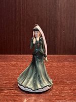 Royal Doulton O Holy Night porcelain figurine ornament shown on wooden surface, front view.