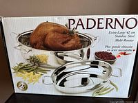 Front view of the Paderno roasting pan box showing branding and a picture of the roasting pan with cooked poultry and vegetables.