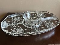 Clear divided glass serving tray with central dip bowl, showing Snowflake Frost pattern and tray divisions, approximate 14x10 inches in size.