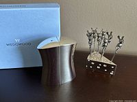 Photo showing the cheese wedge-shaped holder with 8 silver cocktail picks that have mouse figurine toppers; holder decorated with rhinestones.