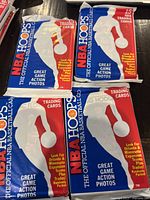 Four unopened packs of 1989 NBA Hoops basketball trading cards in original packaging.