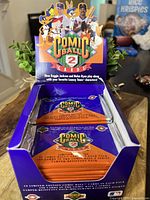 Opened purple display box of 1991 Upper Deck Comic Ball 2 trading cards with visible cartoon characters and baseball players on box.