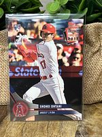 Front of Shohei Ohtani rookie baseball card from 2018 Topps National Baseball Card Day depicting the player batting for the Los Angeles Angels.
