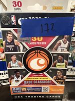 Front of sealed 2020-21 NBA Chronicles box, showing key player images and number of cards per box.
