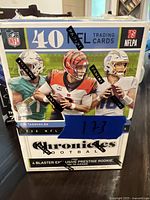 Front view of sealed 2020 Panini Chronicles NFL Football blaster box featuring images of NFL rookie players.