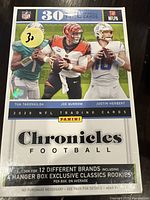 Front of sealed 2020 Panini Chronicles Football trading card box showing images of rookies Tua Tagovailoa, Joe Burrow, and Justin Herbert, and text highlighting 30 NFL trading cards per box.