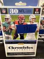 Front of sealed 2020 Panini Chronicles NFL Football hanger box featuring images of NFL QBs Tua Tagovailoa, Joe Burrow, and Justin Herbert and branding details.