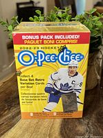 Front of sealed 2022-23 O Pee Chee hockey card box with bonus pack and base set retro variation advertising