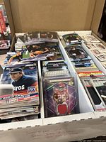 Four-row storage box filled with assorted sports cards