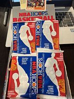 Four unopened 1989 NBA Hoops basketball trading card packs displayed together showing front of packs and original vintage packaging.