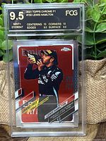 Front of 2021 Topps Chrome F1 trading card featuring Lewis Hamilton, graded 9.5 Mint Plus by FCG, showing race photo and grade label.