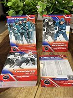 Two stacks of hockey cards including rookie and checklist cards from Upper Deck Hockey Day set