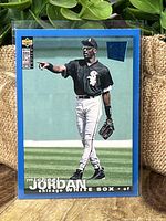Front of Michael Jordan baseball rookie card showing Jordan in Chicago White Sox uniform with blue border and Upper Deck logo.