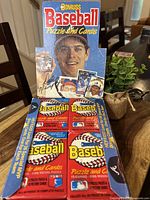 Opened box with 36 sealed Donruss baseball wax packs inside, featuring player images and puzzle promotions on the box.