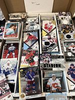 Overhead shot of several boxes filled with stacks of sports cards including hockey memorabilia cards